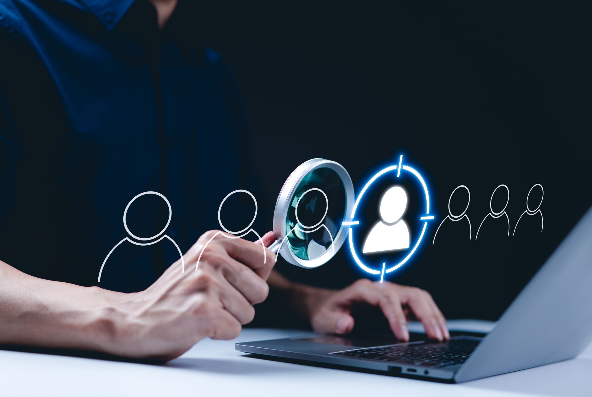 Target customer concept. CRM, Customer relationship management, A person using a laptop with magnifying glass focuses on the target customer icon, customer relationship management (CRM) and targeting.